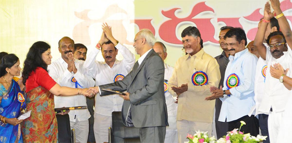 Higher Education Secretary Sumita Dawra and TISS Director S Parasuraman exchange papers after signing MoU as CM N Chandrababu Naidu and Education Minister Ganta Srinivasa Rao look on
